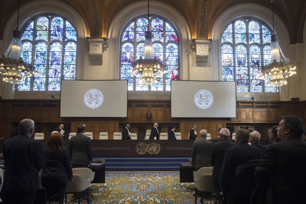 The delegations of the US (front left) and Iran (front right) rise as judges enter the International Court of Justice in The Hague, Netherlands, on October 3, 2018. Photo: AP