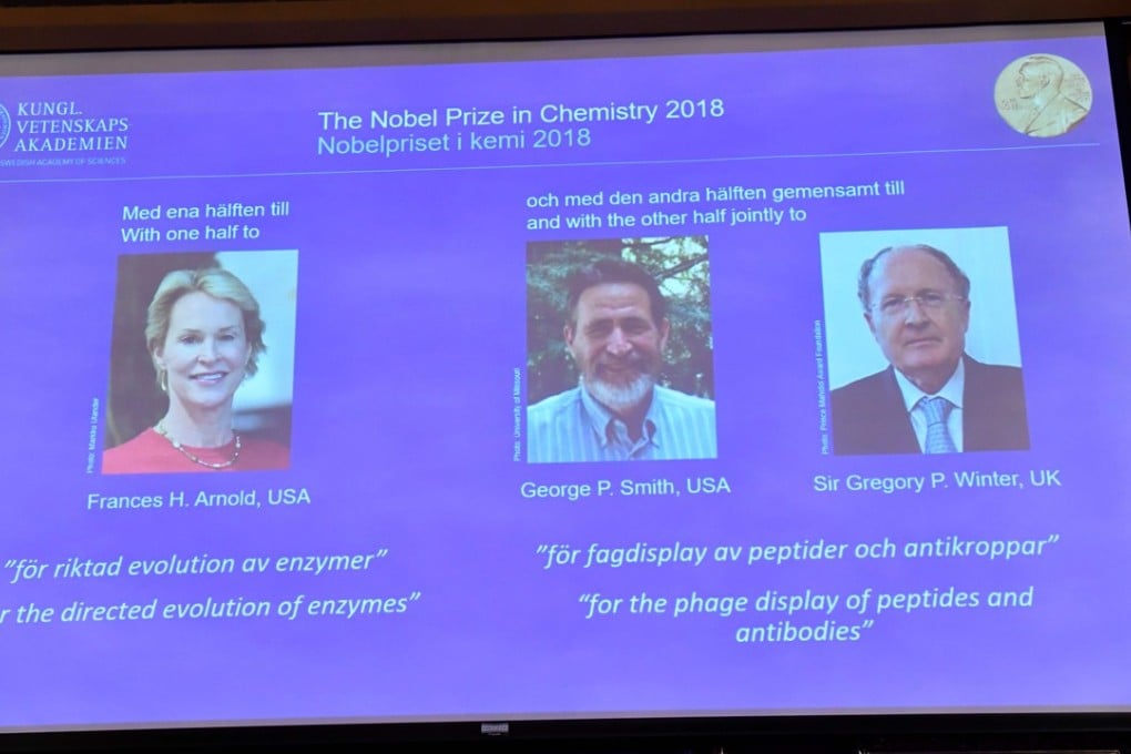 A screen displays portraits of the winners of the 2018 Nobel Prize in Chemistry. Photo: AFP