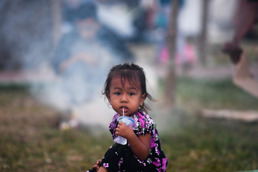 A child drinks water at a makeshift camp in Palu, Indonesia. Photo: AFP