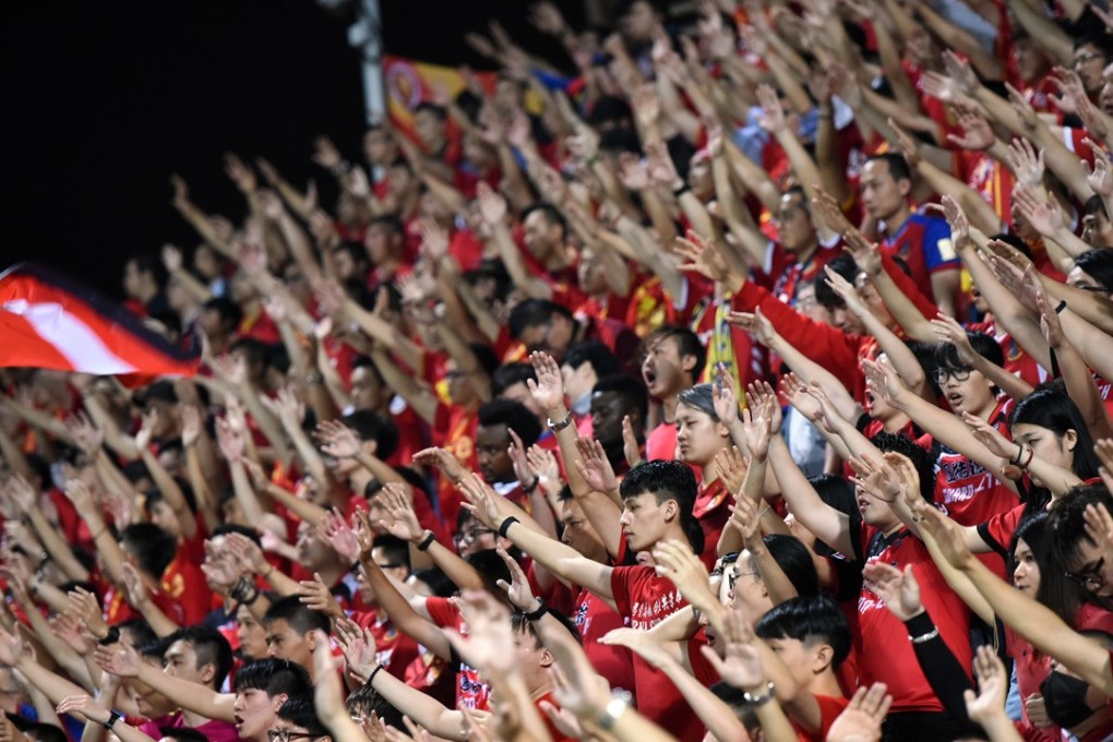 Fans of Guangzhou Evergrande gesture as they watch the AFC Champions League football match against Hong Kong's Eastern at Mong Kok Stadium in 2017. Photo: AFP