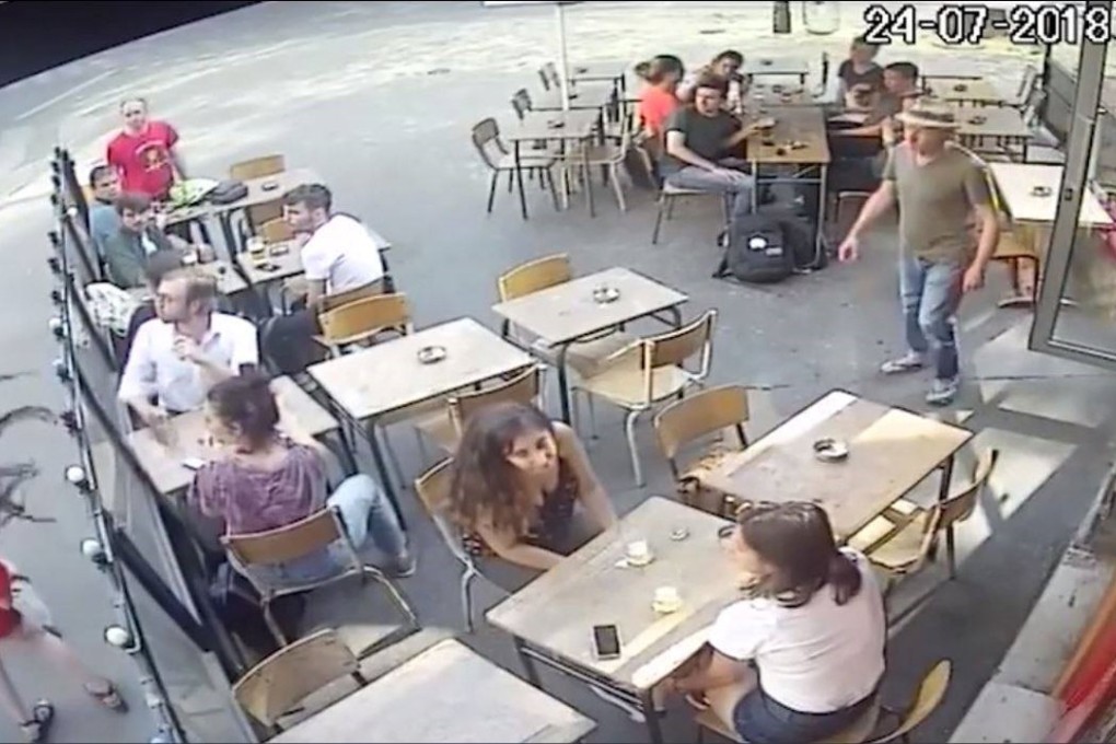 Marie Laguerre's hair goes flying as her head is snapped back by a blow from her attacker, who had sexually harassed her outside a cafe in Paris on Tuesday July 24. Photo: YouTube