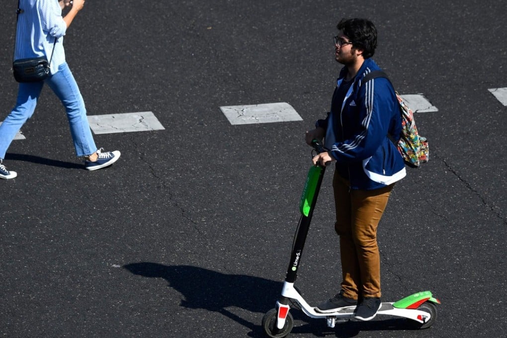 A man uses an electric scooter of the Lime electric scooter-sharing service in Madrid. Photo: AFP