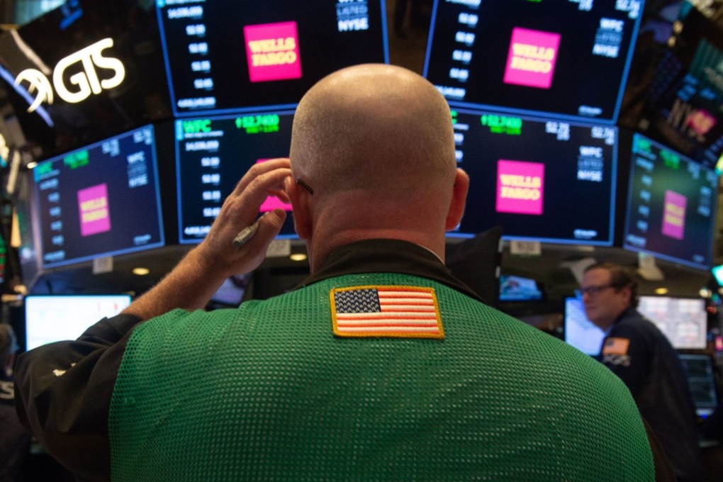 Traders work on the floor of the New York Stock Exchange on October 3. The current bull market rally in US stocks, which started on March 9, 2009, is the longest on record since the second world war. Photo: AFP