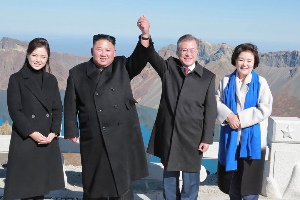 North Korean leader Kim Jong-un and his wife Ri Sol-ju pose with South Korean President Moon Jae-in and his wife Kim Jung-sook on the top of Mount Paektu on September 20 after their summit. Photo: AFP/KCNA via KNS