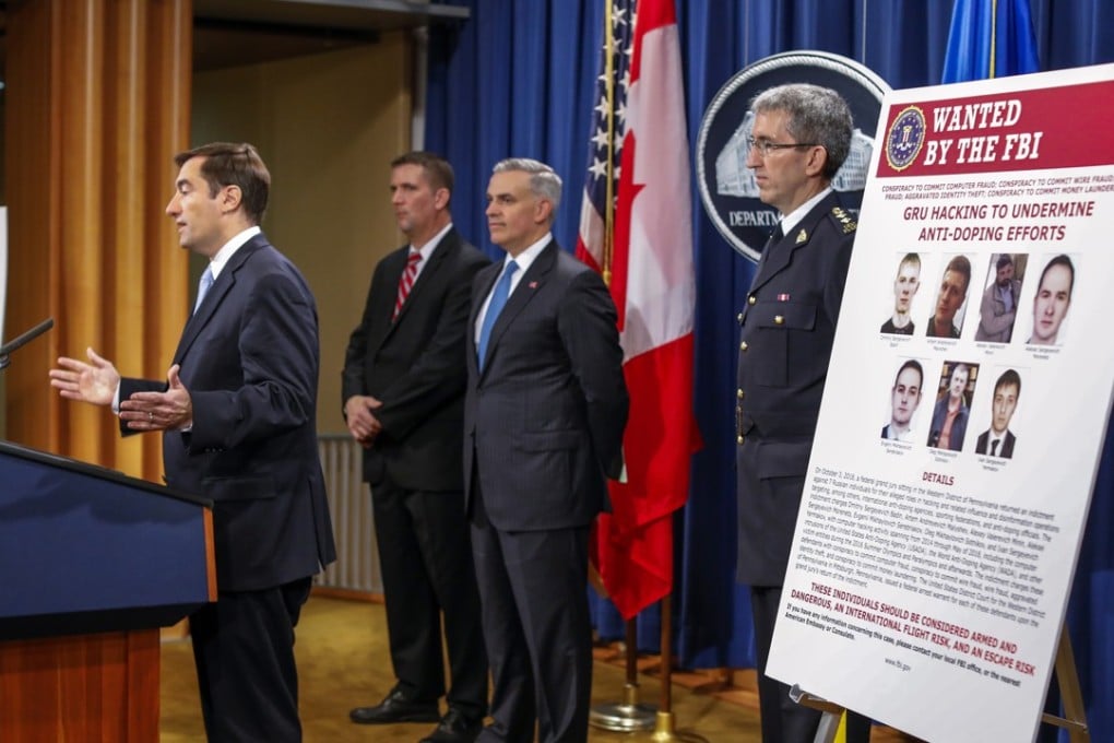 US Department of Justice officials announce criminal charges against seven Russian Federation GRU intelligence officers in Washington on Thursday. Photo: EPA