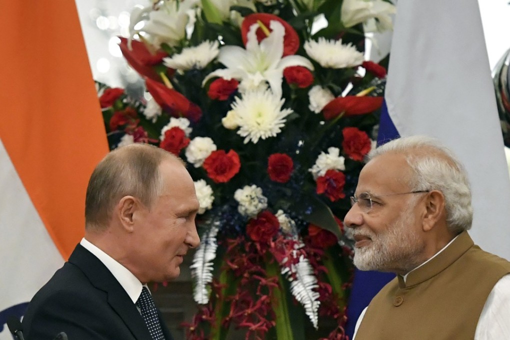 Russian President Vladimir Putin, left, and Indian Prime Minister Narendra Modi shake hands after delivering a joint statement following their talks on Friday. Photo: AP