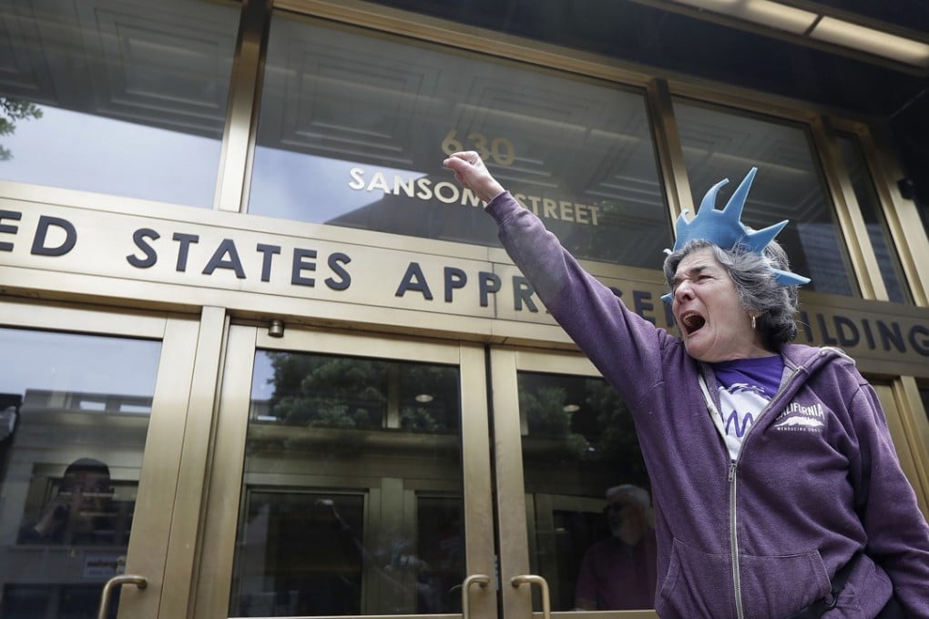 A protester yells outside of the Immigration and Customs Enforcement (ICE) office in San Francisco. Photo: AP