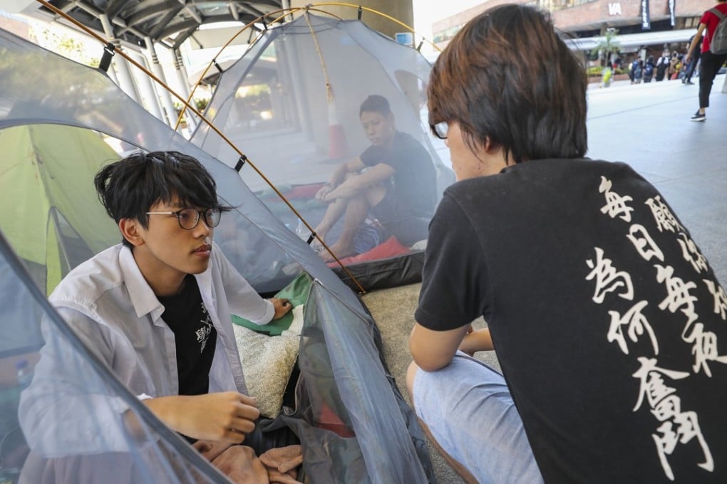 Polytechnic University student union president Lam Wing-hang (left) camps as students protest against the school taking control of their “democracy wall”. Photo: Edward Wong