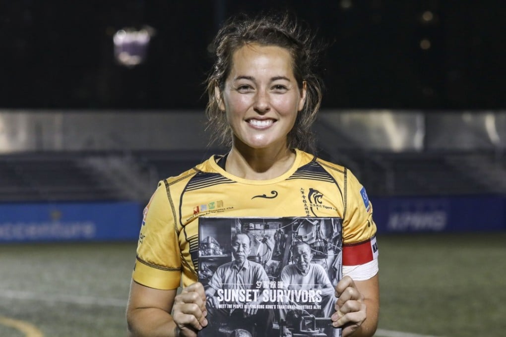 Lindsay Varty of the Tigers with her book ‘Sunset Survivors’ after the women’s Rugby Premiership at King’s Park in Jordan. Photo: Jonathan Wong