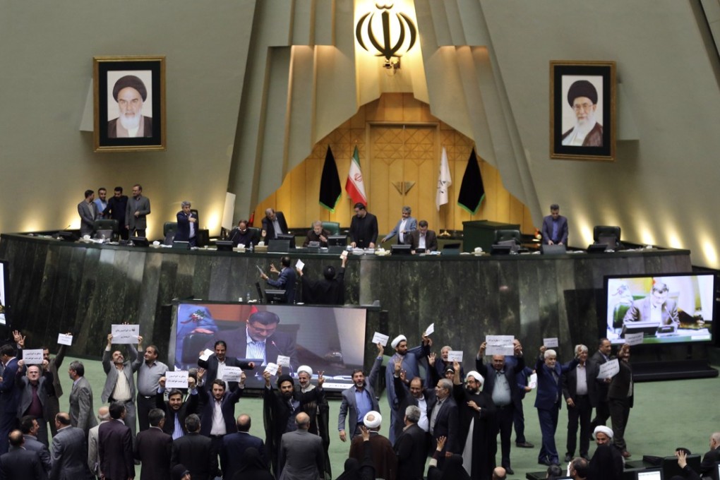 Iranian MPs display their disagreement over a bill to counter terrorist financing in parliament in Tehran. Photo: AFP