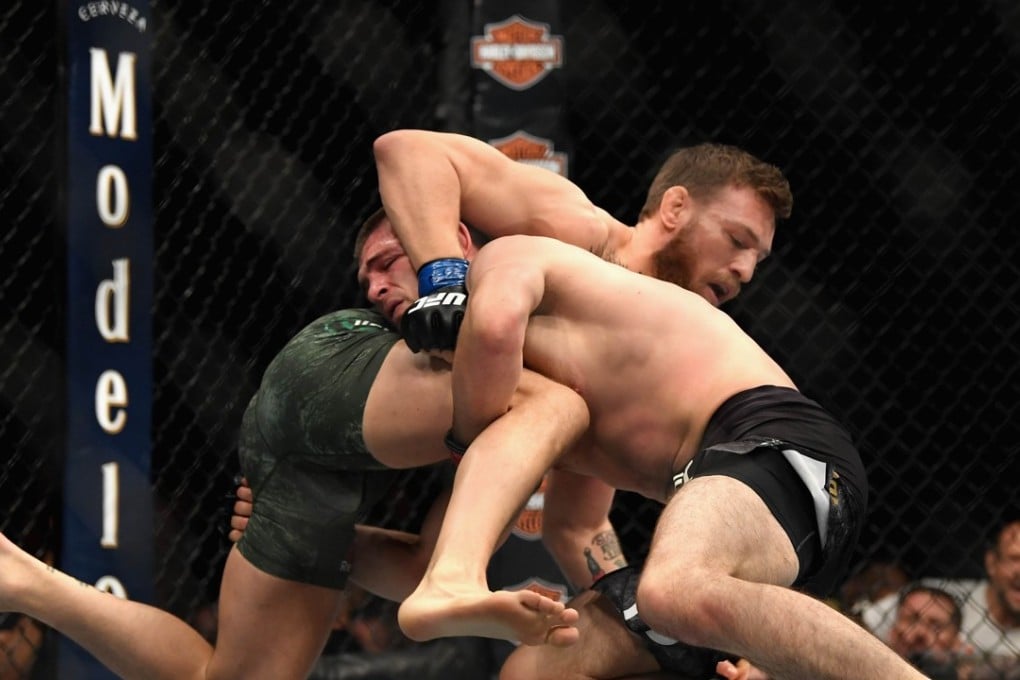 Conor McGregor of Ireland tackles Khabib Nurmagomedov of Russia in their UFC lightweight championship bout. Photo: AFP