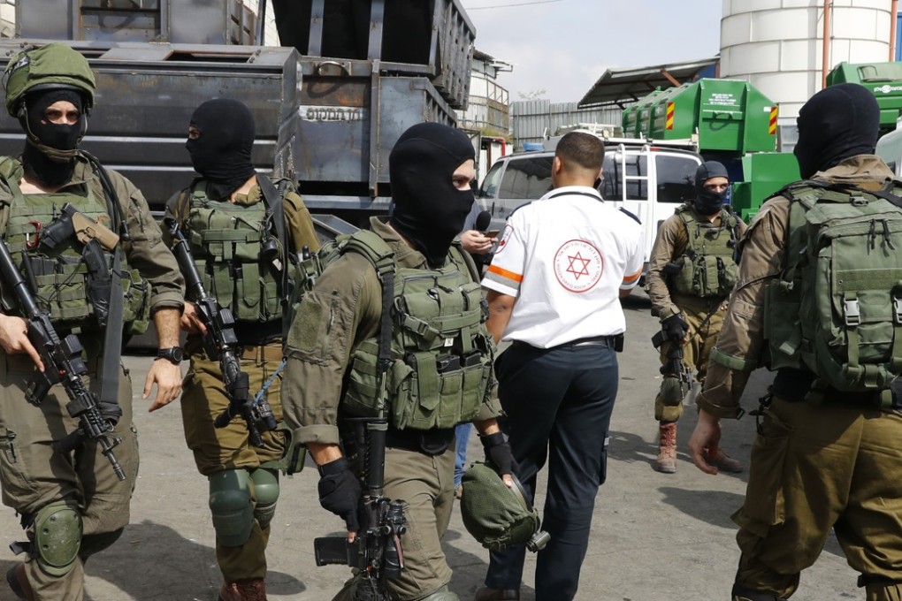 Israeli security forces at the site of a shooting at the Barkan Industrial Park near the Israeli settlement of Ariel in the occupied West Bank. Photo: AFP
