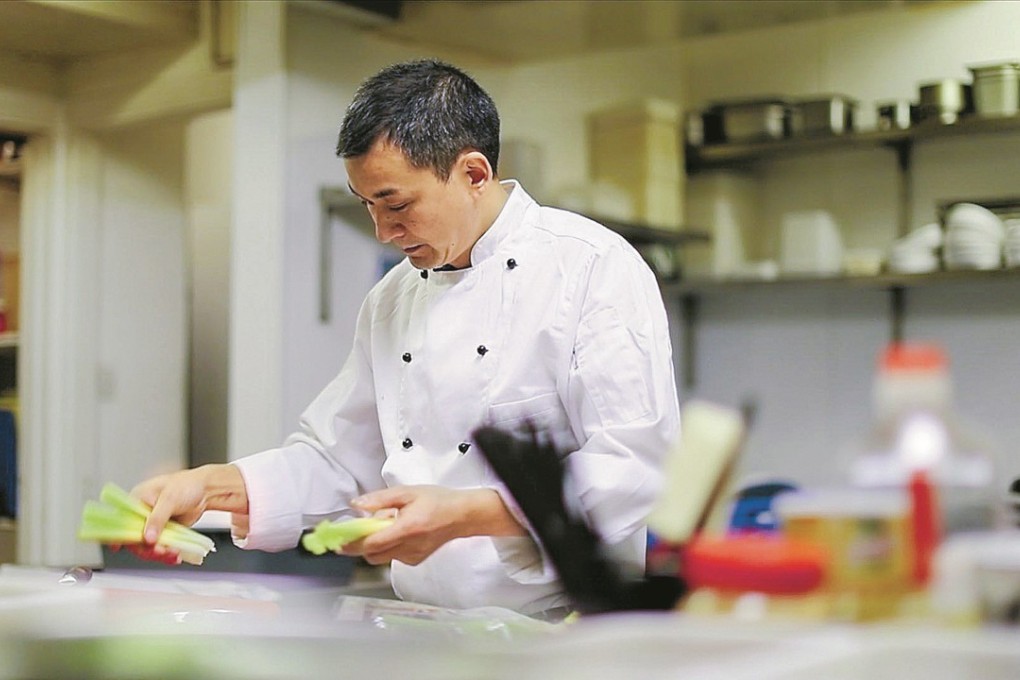 Chef Zhang Xiao Zhong begins prepping a dish in the kitchen of his restaurant The Sichuan in London.