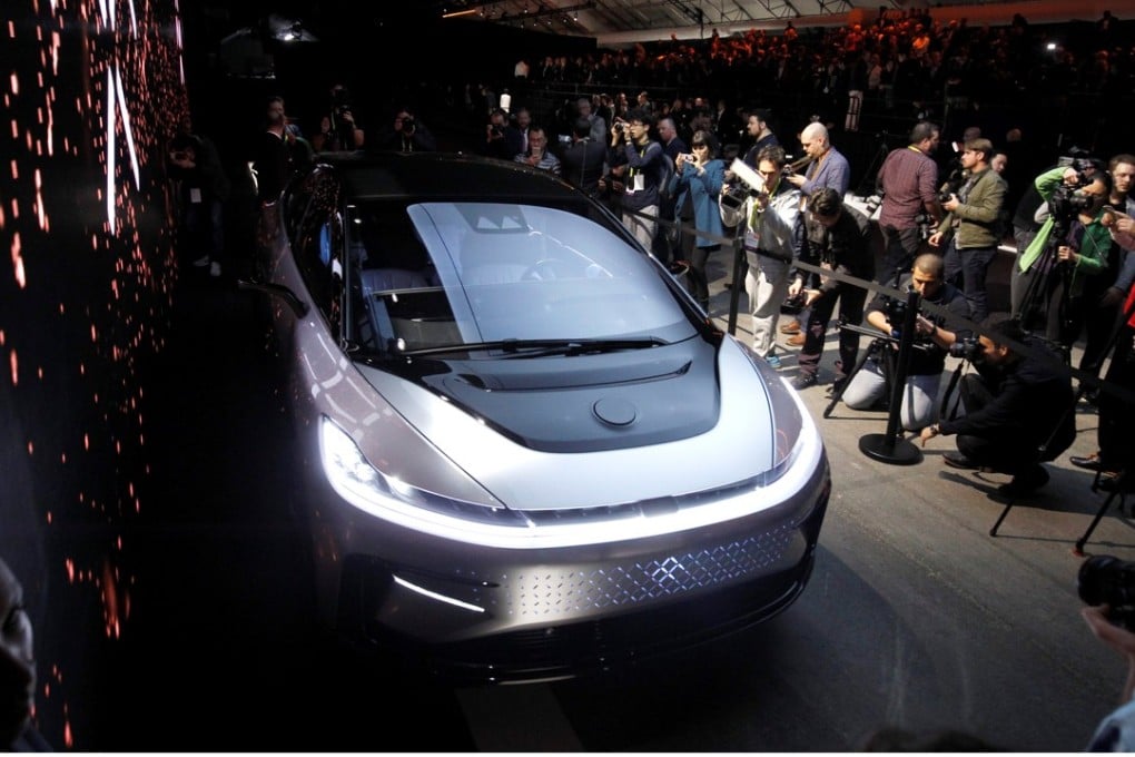 Journalists gather around a Faraday Future FF 91 electric car during an unveiling event at CES in Las Vegas, on January 3, 2017. Photo: Reuters