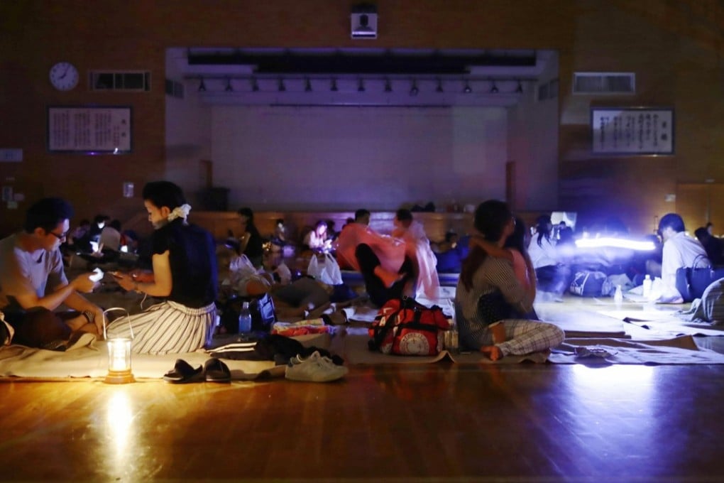 Evacuees at a gymnasium of junior school, acting as an evacuation shelter, during blackout after an earthquake hit the area in Sapporo, Hokkaido. Photo: Reuters