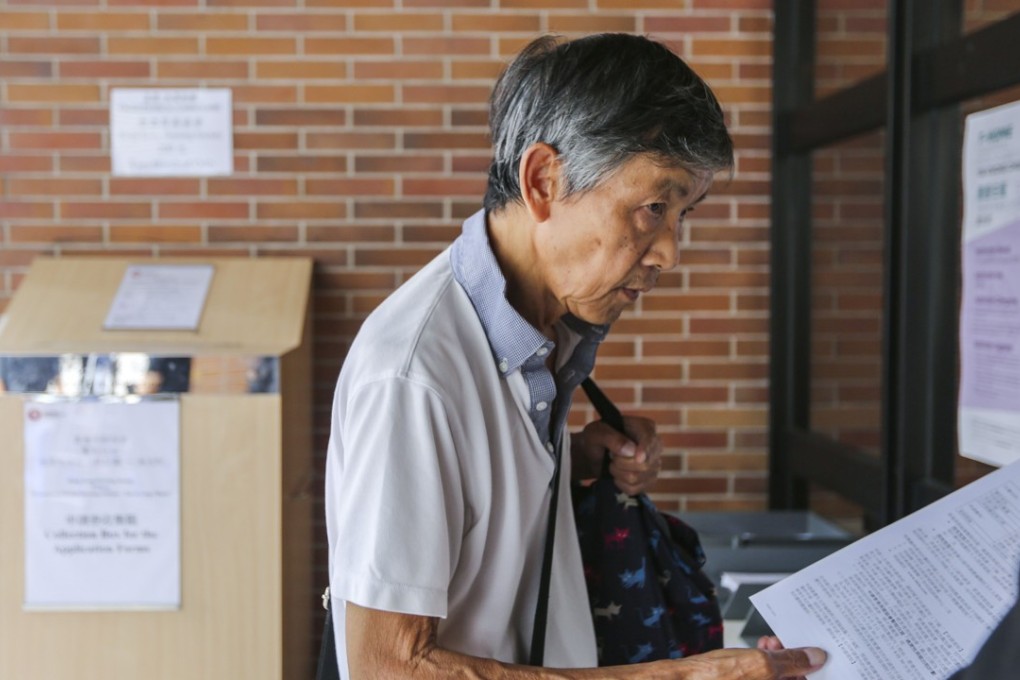 An elderly man applies for a temporary rental housing scheme in Tai Hang. The absence of a public pension scheme, coupled with a mandatory retirement age, can be financially disastrous and mentally devastating for Hong Kong seniors. Photo: Xiaomei Chen