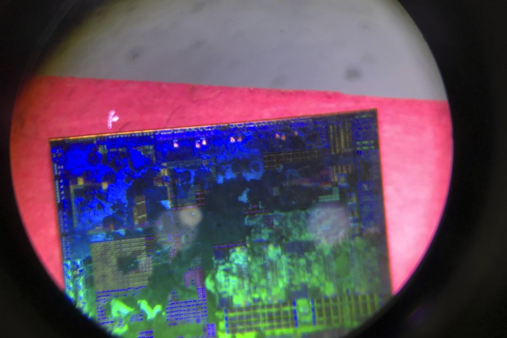 A Chinese microchip developed by Tsinghua Unigroup is seen through a microscope at the 21st China Beijing International High-tech Expo on May 17, 2018. Photo: AP