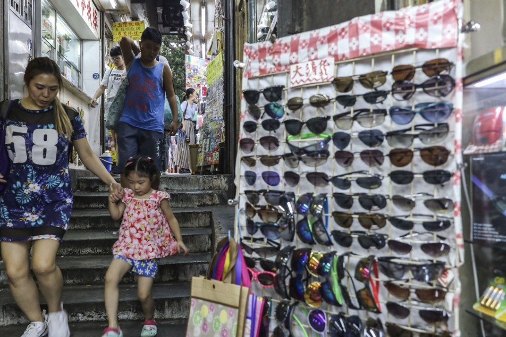Shoppers walk past illegal stores in Yue Man Square in Kwun Tong. Photo: Sam Tsang