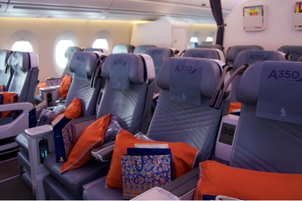 Premium economy class on a Singapore Airlines Airbus A350. Premium economy seats offer a little more legroom and a wider screen, and typically cost twice as much as standard economy. Photo: Alamy