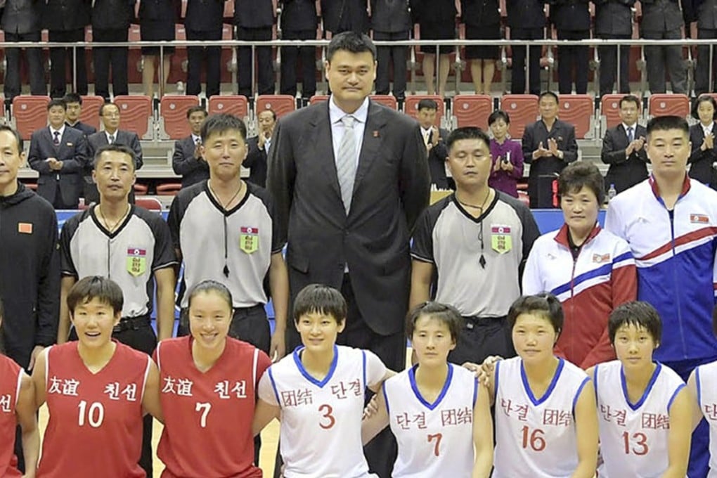 At 2.29 metres (7ft 6in) tall, Yao Ming towers over the participants in Tuesday’s basketball match between teams that mixed Chinese and North Korean players. Photo: AP