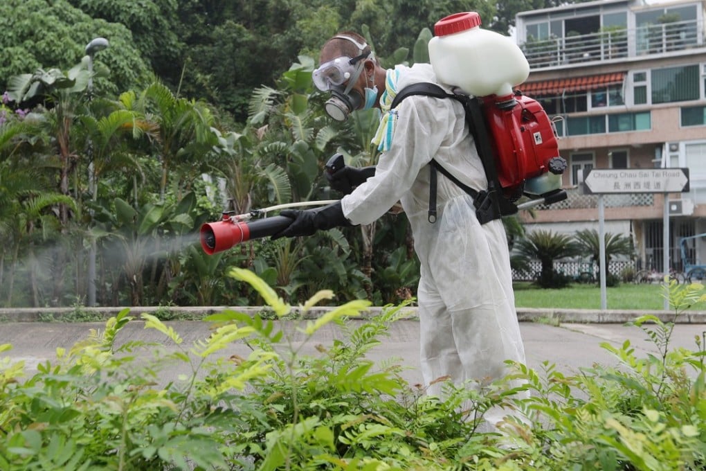 A Food and Environmental Hygiene Department worker carrying out anti-mosquito measures on the Hong Kong island of Cheung Chau. Photo: Edward Wong