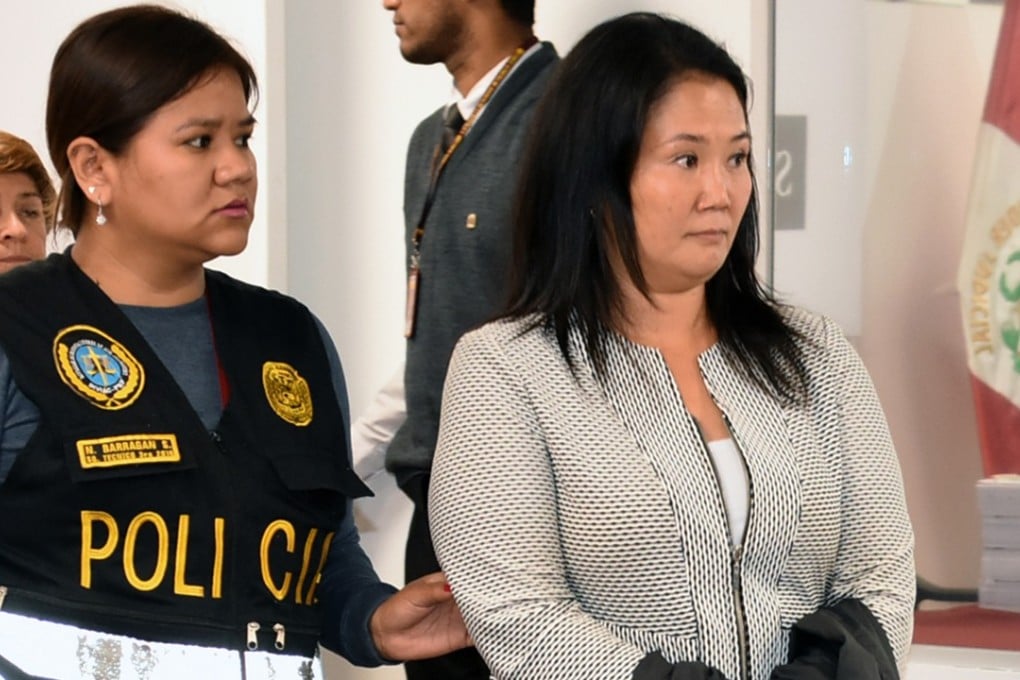 Police escort Keiko Fujimori, opposition leader and daughter of disgraced ex-president Alberto Fujimori. Photo: AFP