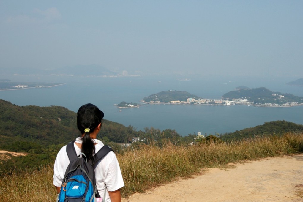 A hiker on Lantau looks across at Peng Chau and other nearby islands. The Hong Kong government aims to reclaim 1,700 hectares off Lantau Island to address housing and other land needs. Photo: Reuters