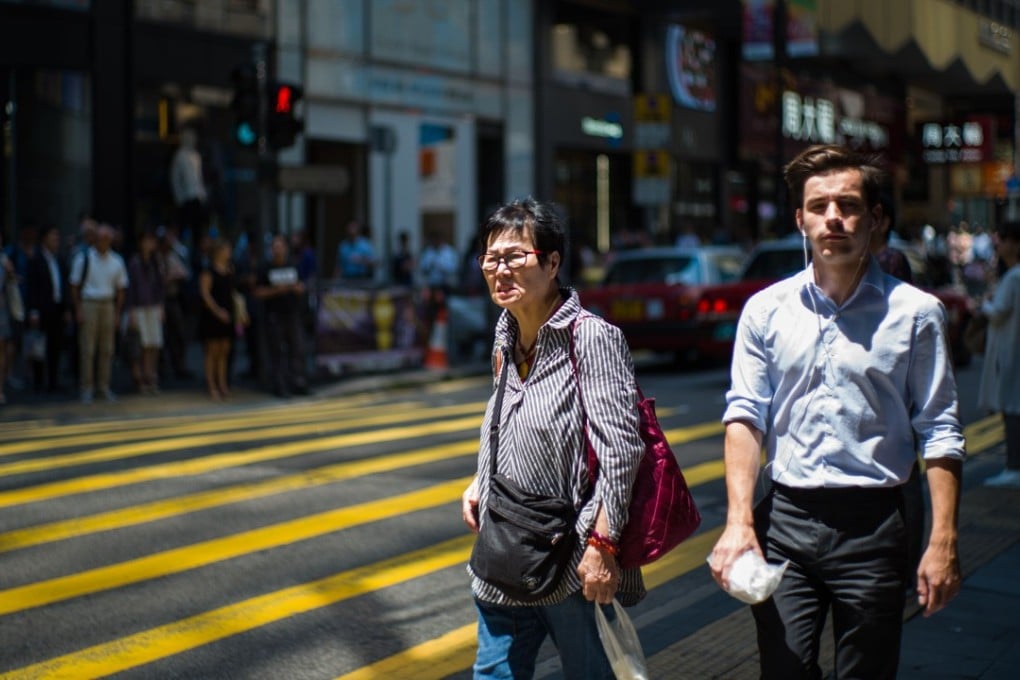 Hong Kong’s high salaries come at a price, with 50 per cent of expatriates saying they work longer hours here. Photo: AFP