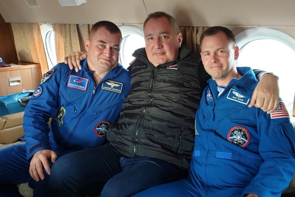 Head of the Russian space agency Roscosmos Dmitry Rogozin (centre) with astronauts Alexey Ovchinin of Russia and Nick Hague of the US, who survived the mid-air failure of a Russian rocket. Photo: Handout