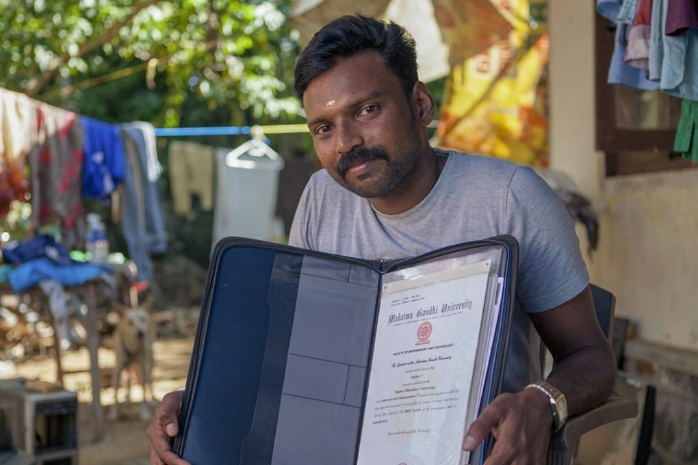 Arun Thankappan – and dog Messi in the background – with his graduation certificate, one of the few belongings he was able to save when his home in Kochi was flooded, on August 15. Picture: Andreas Vingaard for Orb Media.