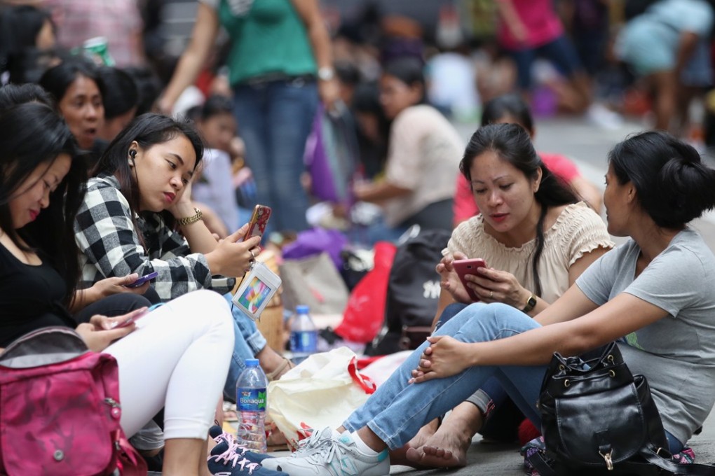 Domestic workers gather in Central on a public holiday. Photo: Edward Wong