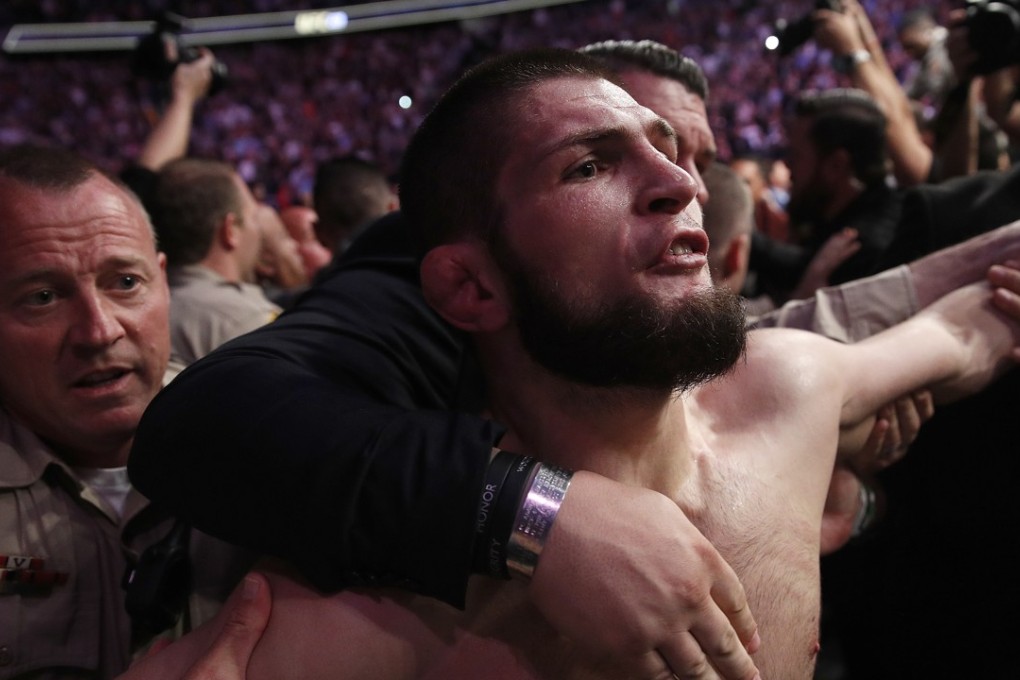 Khabib Nurmagomedov is held back outside the Octagon after submitting Conor McGregor at UFC 229 in Las Vegas. Photo: AP