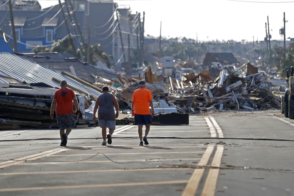 People walk amid destruction on the main street of Mexico Beach, Florida, in the aftermath of Hurricane Michael on Thursday. Photo: AP Photo