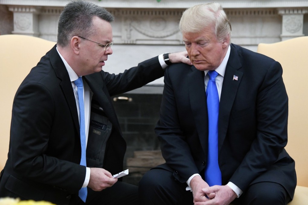 Pastor Andrew Brunson placed a hand on Donald Trump’s shoulder and prayed for God to give him ‘supernatural wisdom’. Photo: TNS