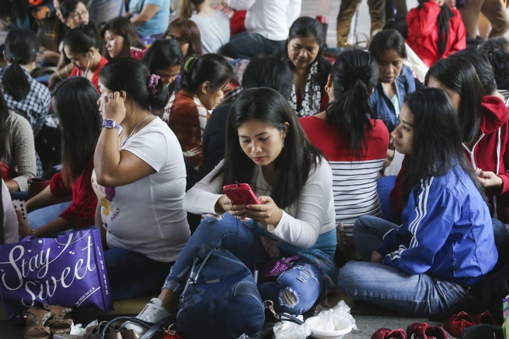 Filipino domestic workers sit on a street on a Sunday in Hong Kong. Photo: Dickson Lee