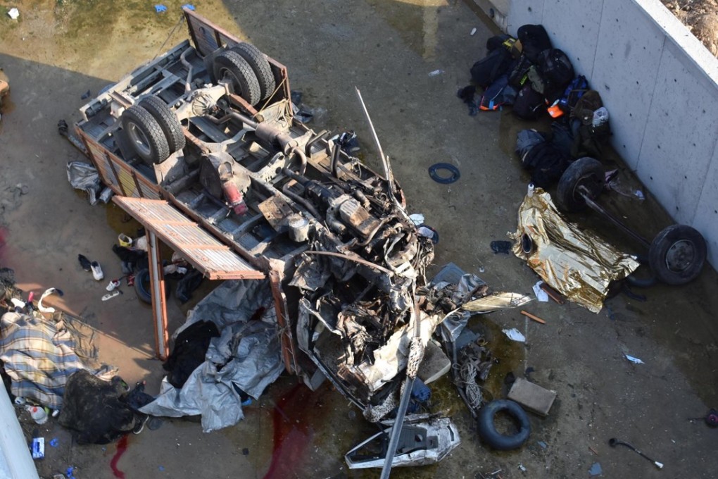 The truck had been travelling on a highway near to Izmir airport when it flipped over and fell into the channel several metres below. Photo: Reuters