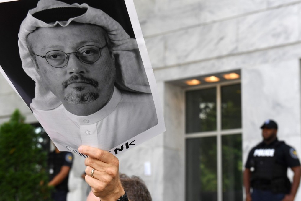 A demonstrator holding a photo of journalist Jamal Khashoggi outside the embassy of Saudi Arabia in Washington on Wednesday. Photo: Washington Post