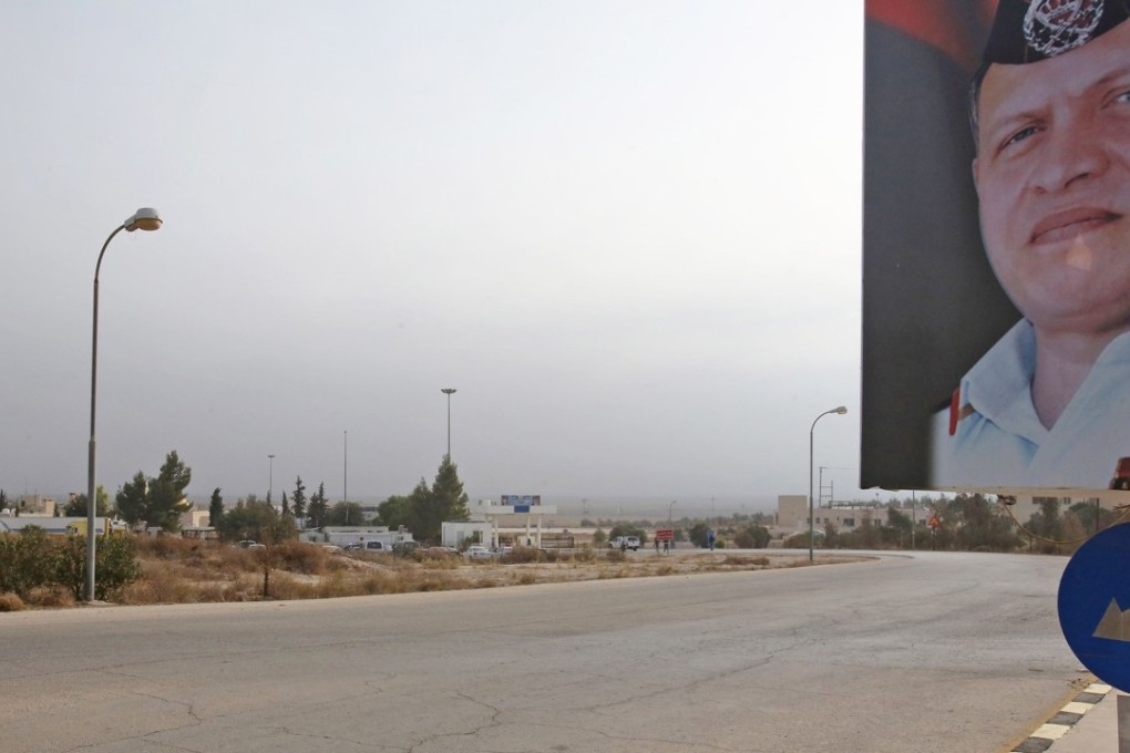 A portrait of Jordan's King Abdullah on the road to the border crossing between Jordan and Syria. Photo: AFP