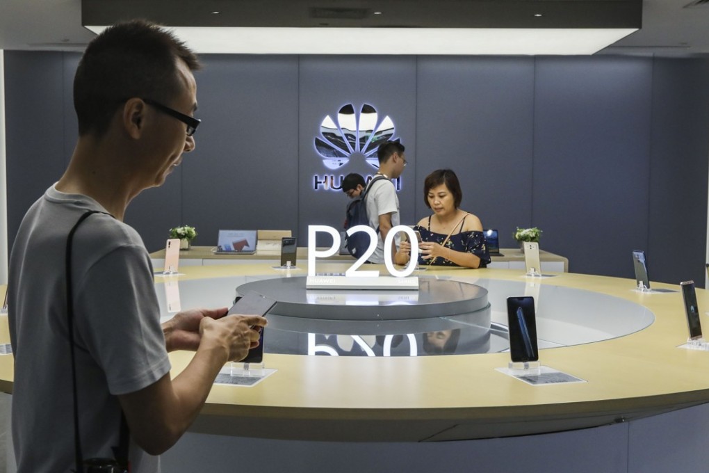 Customers check out the Huawei P20 mobile phone on display at the Huawei store in the Consumer Electronics Exchange/Exhibition Centre (CEEC) in Futian district, Shenzhen on September 4, 2018. Photo: SCMP/Roy Issa