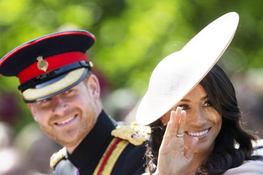 Britiain's Prince Harry, The Duke of Sussex and Meghan, The Duchess of Sussex are wave in a carriage during the Trooping of the Colour. The newlyweds arrived in Sydney on Monday for a two week visit to the region. Photo: EPA