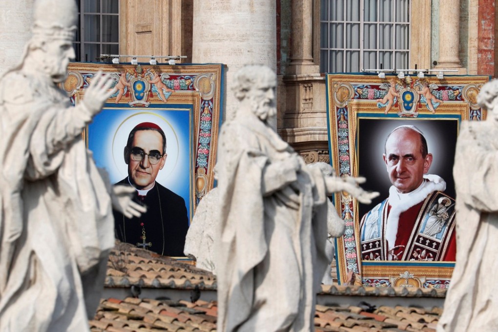 Pope Paul VI and El Salvador's Archbishop Oscar Romero pictures are seen during a Mass for their canonisation at the Vatican on October 14. Photo: Reuters
