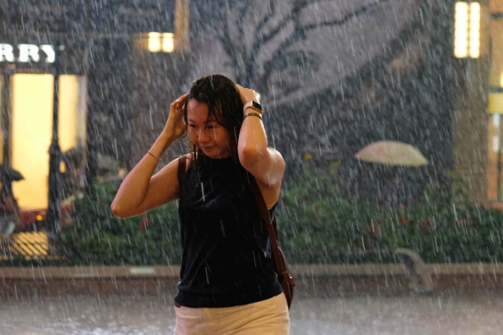 A pedestrian caught without an umbrella walks under heavy rain in Causeway Bay in August 2017. Photo: Fung Chang