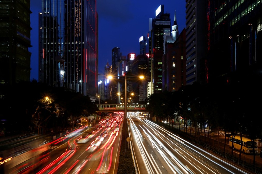Traffic flows between office buildings at sunset in Wan Chai in June 2017. Hong Kong has been slow to adopt an open access data platforms, such as those that could speed up tackling traffic problems, for example. Photo: Reuters