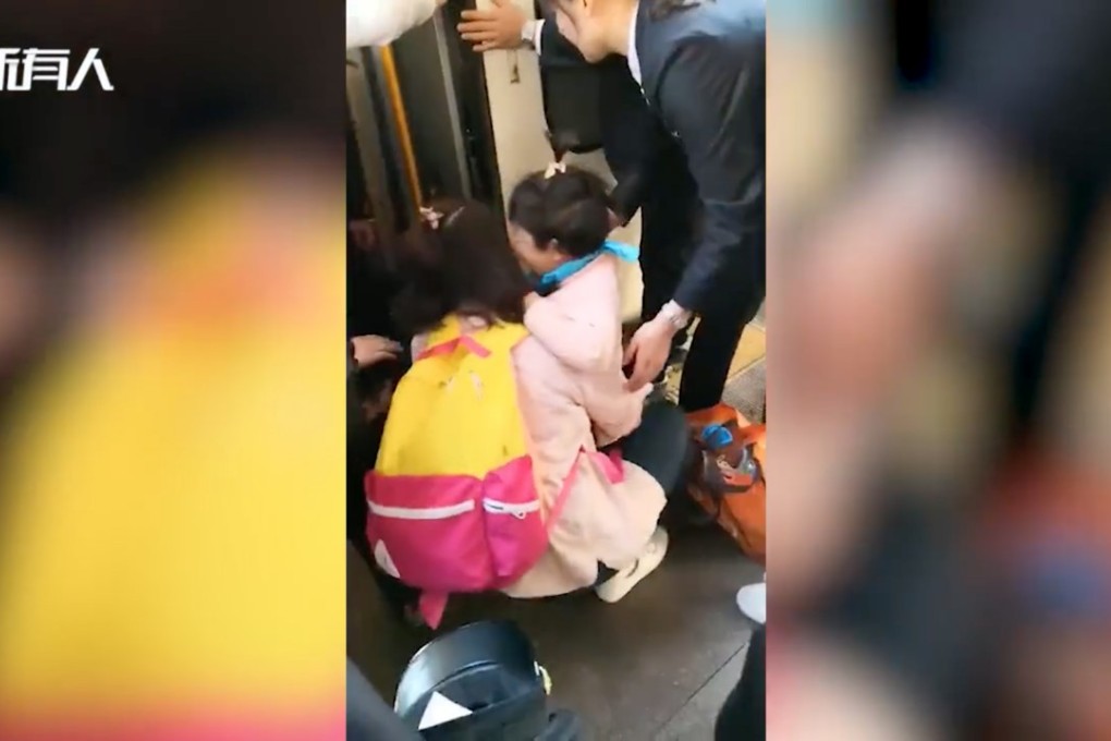 A young girl is reunited with her mother after falling under a stationary train in Beijing. Photo: Thepaper.cn