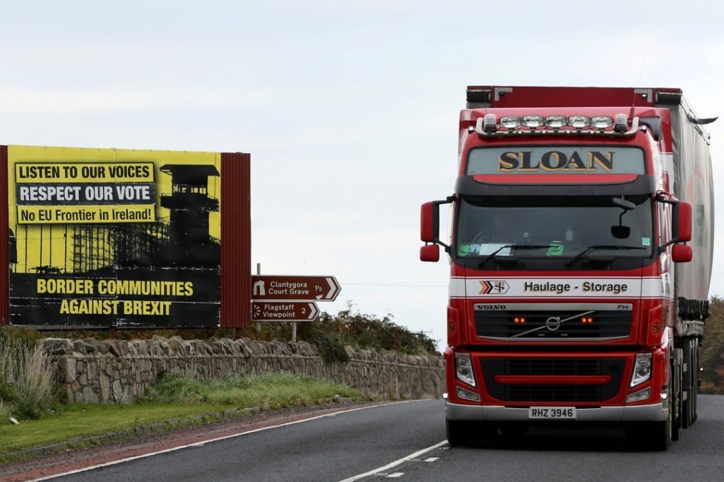 Traffic passes a Brexit Border poster on the Dublin Road Co Armagh border, between Newry in Northern Ireland and Dundalk in the Irish Republic. Photo: AFP
