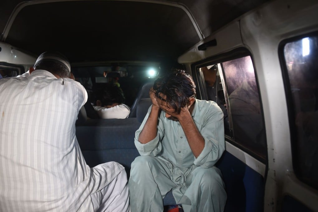 Relatives cover their faces as they arrive at Kot Lakhpat jail to receive the body of Imran Ali, who was executed for raping and murdering a six-year-old girl. Photo: AFP