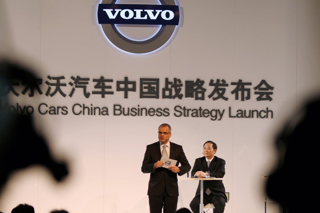 Volvo’s Chief Executive Officer Stefan Jacoby speaks as Li Shufu, Chairman of the Board at Volvo Car Corporation and Chairman of Zhejiang Geely Holding Group Company looks on in Beijing on February 25, 2011. Volvo plans to invest as much as US$11 billion worldwide over the next five years to tap rising demand in markets including China. Photo: SCMP/Simon Song