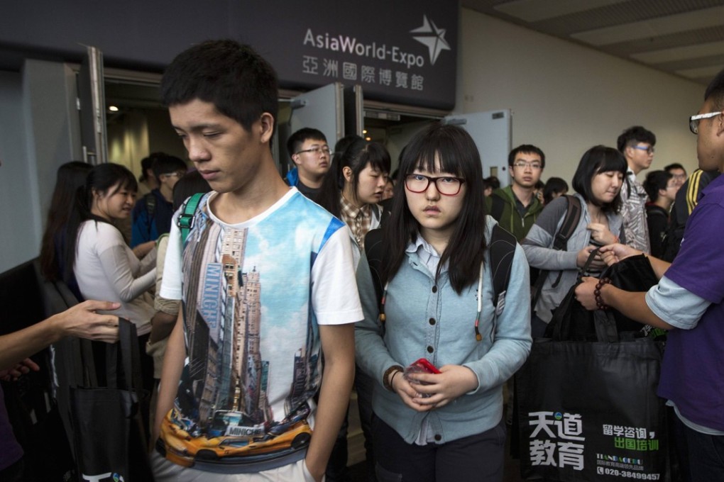 Students leave after sitting an SAT exam at AsiaWorld-Expo in Hong Kong. Photo: Reuters/Tyrone Siu