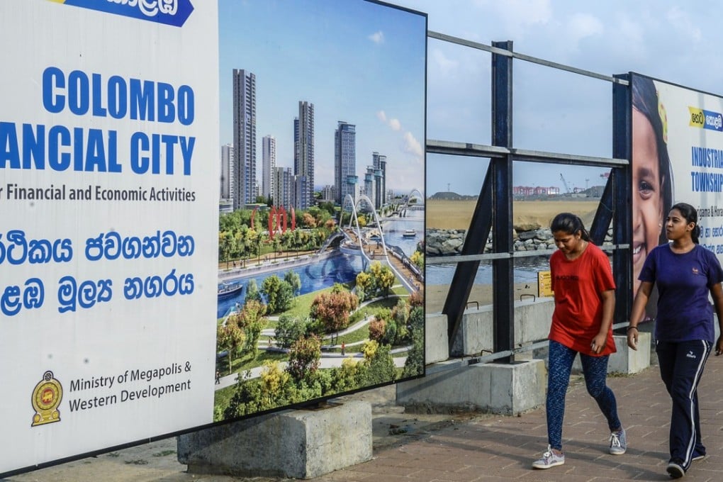 Pedestrians walk past signs for the Colombo International Financial City project in Colombo, Sri Lanka, on March 31. The Colombo Port City project is financed by China Harbour Engineering Company, as part of Chinese President Xi Jinping's Belt and Road Initiative. Photo: Bloomberg