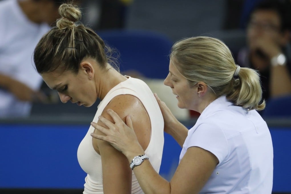 Simona Halep receives medical treatment during her second round match against Dominika Cibulkova at the Wuhan Open. Photo: EPA